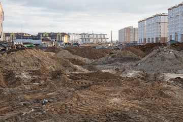 construction site of new buildings with industrial mud in foreground