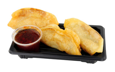 Vegetarian Japanese gyoza snack pack with sweet chilli dipping sauce isolated on a white background