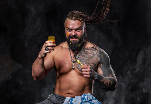 athletic man with beard and tattoos