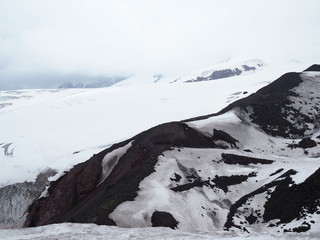 Beautiful view of the mountains in the area of Elbrus. Panorama overlooking the top of the mountain covered with snow
