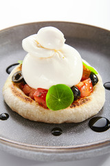 Burrata on rye pita with tomatoes and olives closeup view