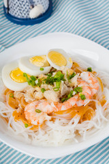 thick rice noodles with shrimp sauce, crispy pork skin and boiled egg also known as palabok