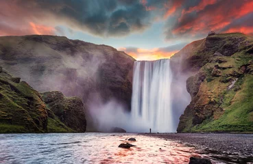 Foto op Canvas Icelandic Landscape. Classic long exposure view of famous Skogafoss waterfall with colorful sky during sunset. Skoga river, highlands of Iceland, Europe. Popular Travel destinations. Amazing nature © jenyateua