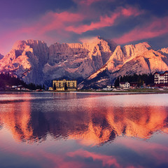 Fantastic Colorful Sunset over the Misurina lake. majestic rock mount on background with reflections. Amazing nature landscape. Wonderful Picturesque scenery of Dolomites Alps. postcard