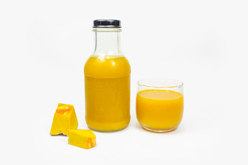 Fresh pumpkin juice in glasses and bottles , Healthy fruit. On white background