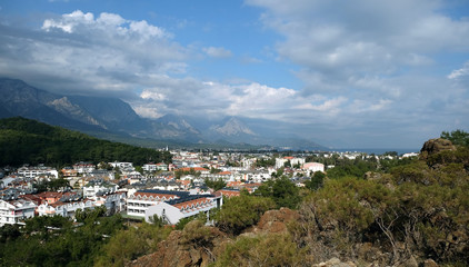 Panoramic view from observing place point to valley with Kemer city in Antalya region surrounded by high mountains and calm blue Mediterranean sea on bright sunny day