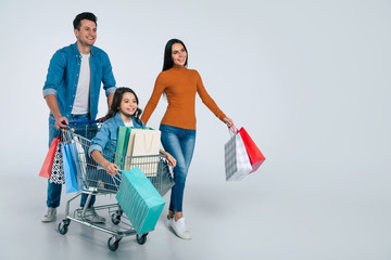 Abundance of purchases. Full-length photo of husband and wife, carrying a lot of newly bought items...