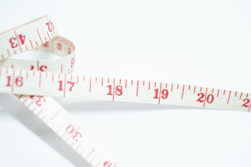 Tape measure in hand on white background.