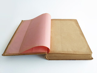Close up of open old book bound in parchment. Antiques empty pages of ocher color on white...