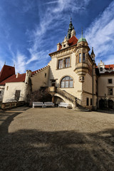 Fototapeta na wymiar Palace of Pruhonice castle with red roof and cloudy sky