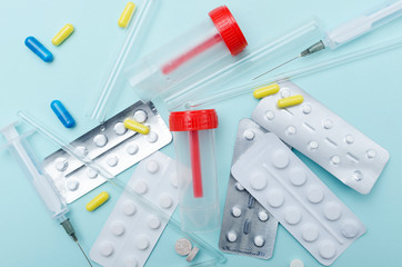 Top view of empty urine container test, laboratory stirring  rods, syringes, drugs, blister packs...