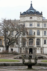 Fototapeta na wymiar Central part of Ploskovice chateau palace with tree and empty fountain