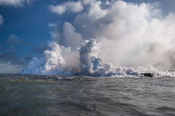 Fototapeta na wymiar steam from the hot lava entering the sea