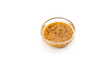 Mustard sauce in a bowl isolated on white backround.