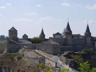 Naklejka premium Medieval castle in the city of Kamyanets-Podilsky, Ukraine . It is a formidable, strong fortress, whose walls are cut out of solid rock. The fortress stands at the top of a precipitous cliff . 