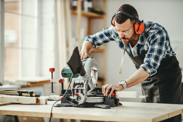 young male carpenter working in  workshop.