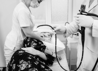 Doctor holding endoscope and conducts colonoscopy 