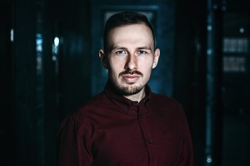 Portrait of a handsome man in an maroon shirt