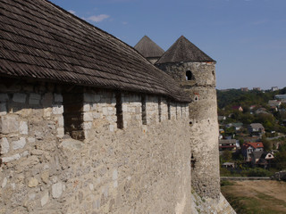 Fototapeta na wymiar Medieval castle in the city of Kamyanets-Podilsky, Ukraine . It is a formidable, strong fortress, whose walls are cut out of solid rock. The fortress stands at the top of a precipitous cliff . 