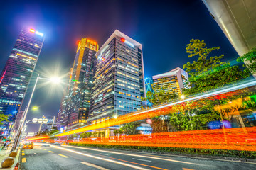 Fototapeta na wymiar Light trace of modern architecture background in Shenzhen Financial District..