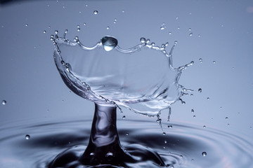 Water drops collision on a blue background. Abstract clear nature background