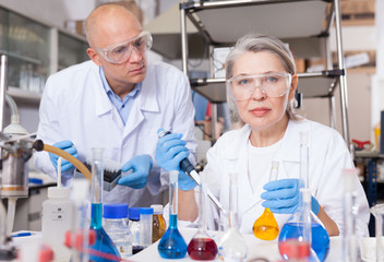 Scientists mixing reagents