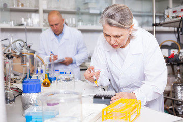 Female chemist mixing chemical agents