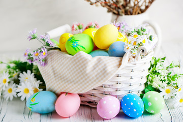 Happy Easter. Congratulatory easter background. Easter eggs and flowers. Background with copy space. Selective focus.