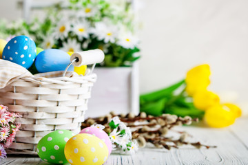Happy Easter. Congratulatory easter background. Easter eggs and flowers. Background with copy space. Selective focus.