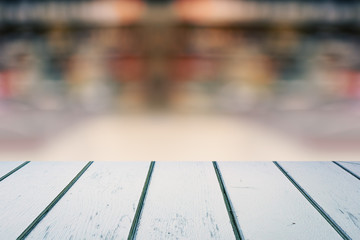 White Wooden Planks Table with Blurred Store on Background