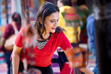 Happy women shopping for souvenirs at street market