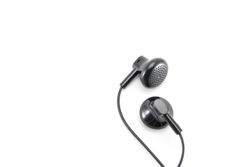 Two small black audio earphones with wire. A mobile headset that plugs into your ear to listen to music. Abstraction on a high quality white isolated background.