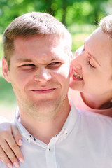 Young couple - girl bites guy to an ear
