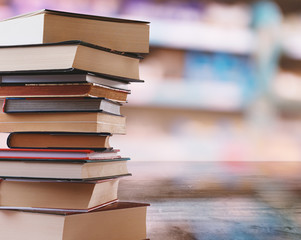Books Pile on Blurred Bookstore or Library Background