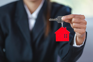 Real Estate Agents Catch Red House Keychains Real estate concept, mortgage, home agent, contract to...