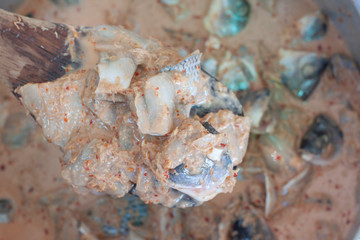 Raw Steamed Fish Curry on spatula to stir the ingredients together Thai people call Homok.