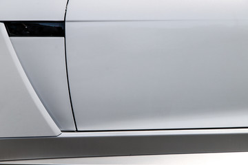 the door of a powerful white sports car. closeup of a Jaguar F-type hood