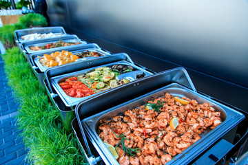 Healthy grilled shrimps and vegetables in buffet.