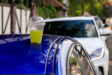 lemonade in a road trip. a cup of lemonade is on the roof of a car