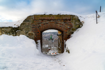 View of the cathedral through the Kristiansten Fortress gate. Winter panorama of the city of Trondheim. Norway