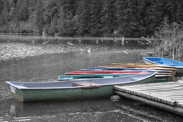 Colored boats on the waterfront waiting for those who want to walk on the lake