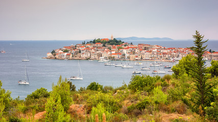 Amazing panoramic view of Primosten old town on the islet, Dalmatia, Croatia. Scenic seascape and city with medieval architecture, famous tourist resort on Adriatic seacoast, outdoor travel background