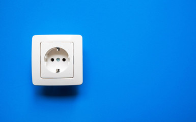 white electrical outlet on isolated blue background