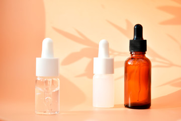 Different cosmetic bottles on the bed background, with contrasting shadows, organic product, Alternative medicine. Copy space.