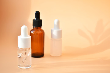 Different cosmetic bottles on the bed background, with contrasting shadows, organic product, Alternative medicine. Copy space.