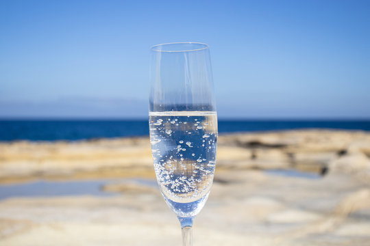 Beautiful photo composition of glasses of bubbly champagne drinks on the beach.