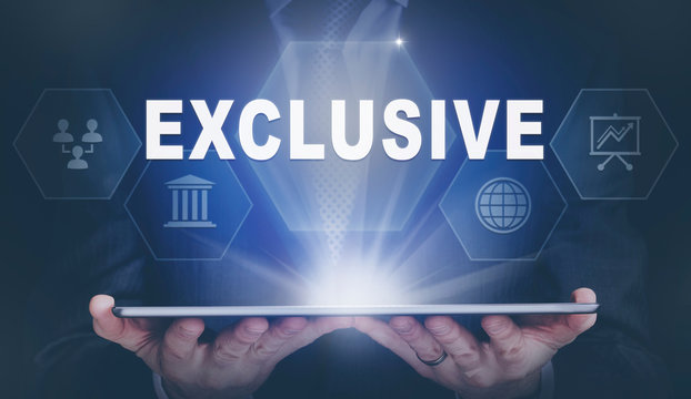 Businessman holding a computer tablet display projecting a Exclusive concept.