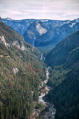 Obraz premium Vertical view of Yosemite valley in Yosemite national park, California, USA in sunny day with dramatic sky above. Mountain landscape. Travel tourism destination in CA, America. Wild forest.