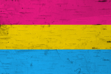 Fototapeta premium A rustic old pansexual flag on weathered wood