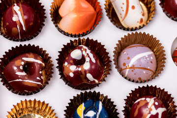 Close Up Luxury Bonbons Painted with Differents Colors in White Box Beautiful and Exclusive Handmade Chocolate Candy Horizontal